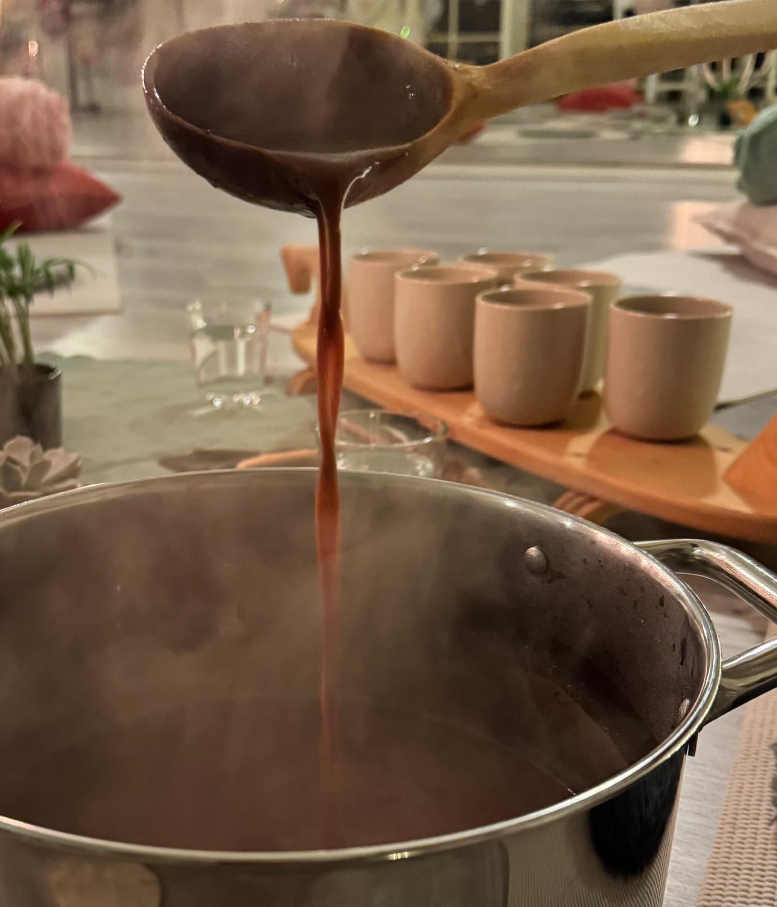 Close-up of a dandelion seed head with delicate white fibers against a blurred green background.